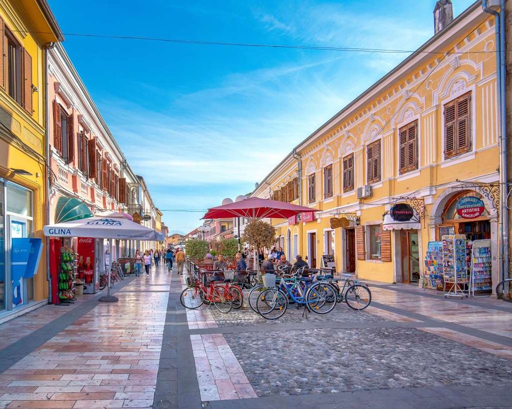 Shkodra pedestrian boulevard with historic buildings and bicycles